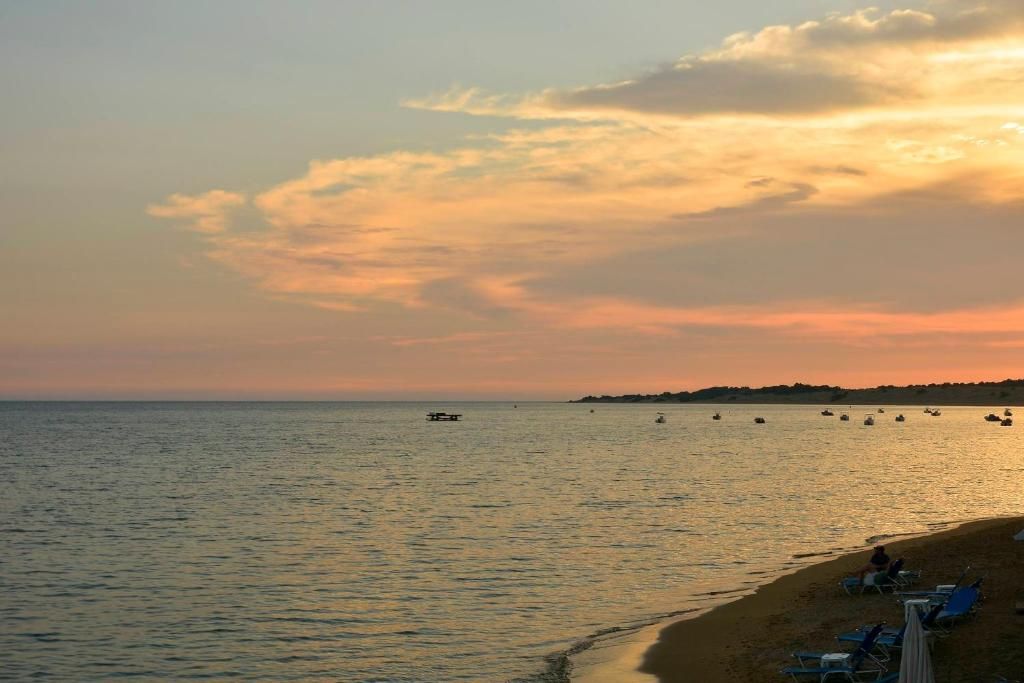 Sunset over the bay of Agios Georgios with boats at anchor