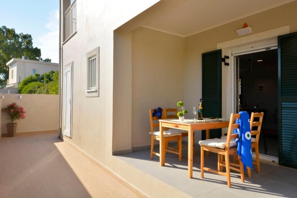 Shaded terrace with a dining table outside the villa